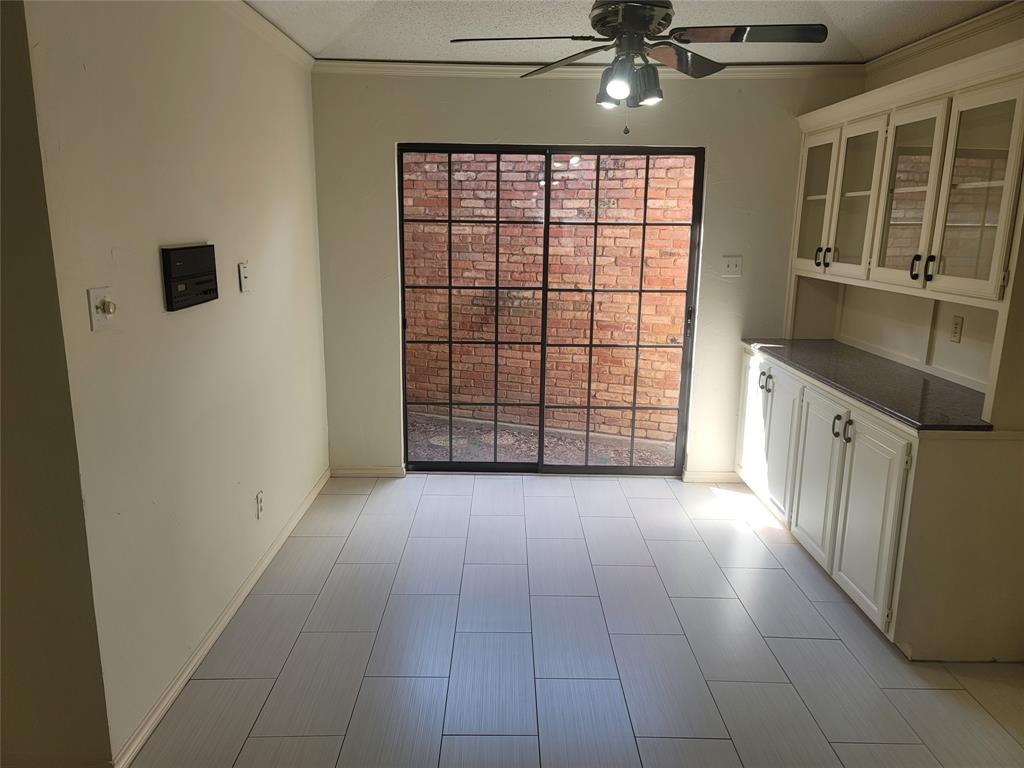 5719 Encore Drive Dallas, TX 75240 - Photo 5 of 21 a view of a kitchen with an empty space and a window