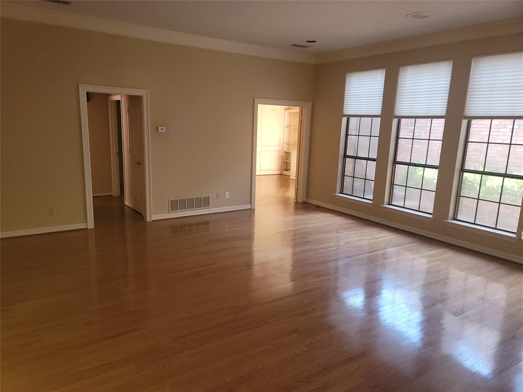 5719 Encore Drive Dallas, TX 75240 - Photo 7 of 21 wooden floor in an empty room with a window
