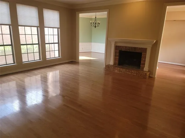 wooden floor in an empty room with a fireplace