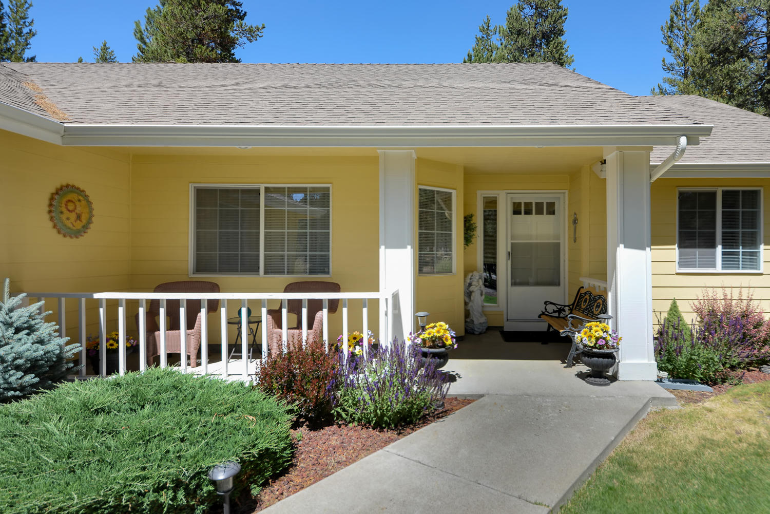 52311 Ammon Road La Pine, OR 97739 - Photo 3 of 39 a view of a house with potted plants in front of door