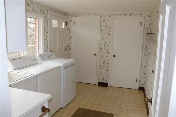 a room with a sink a mirror and a shower
