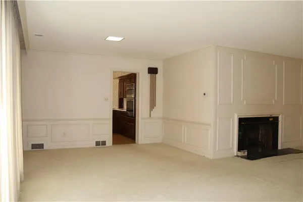 a view of an empty room with a fireplace