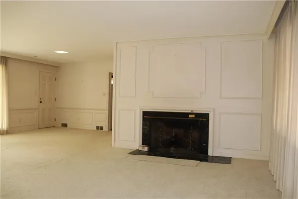 a view of empty room with a fireplace