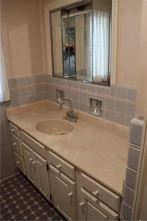 a bathroom with a sink and a mirror