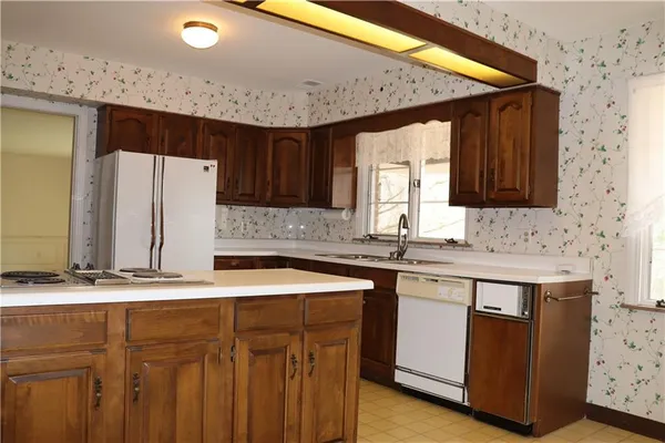 a kitchen that has a sink and a stove in it