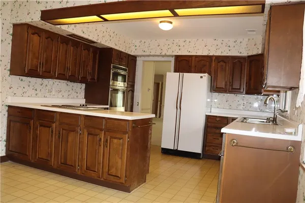 a kitchen with stainless steel appliances a refrigerator and a sink