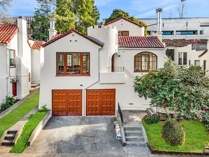 a front view of a house with a garden