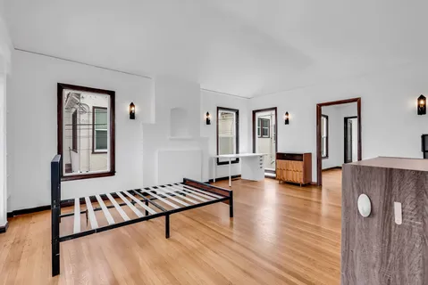 a living room with furniture window and wooden floor
