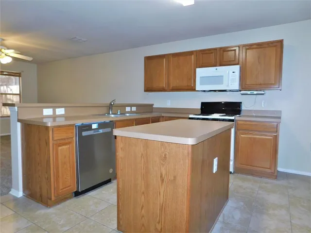 a kitchen that has a sink and a stove in it