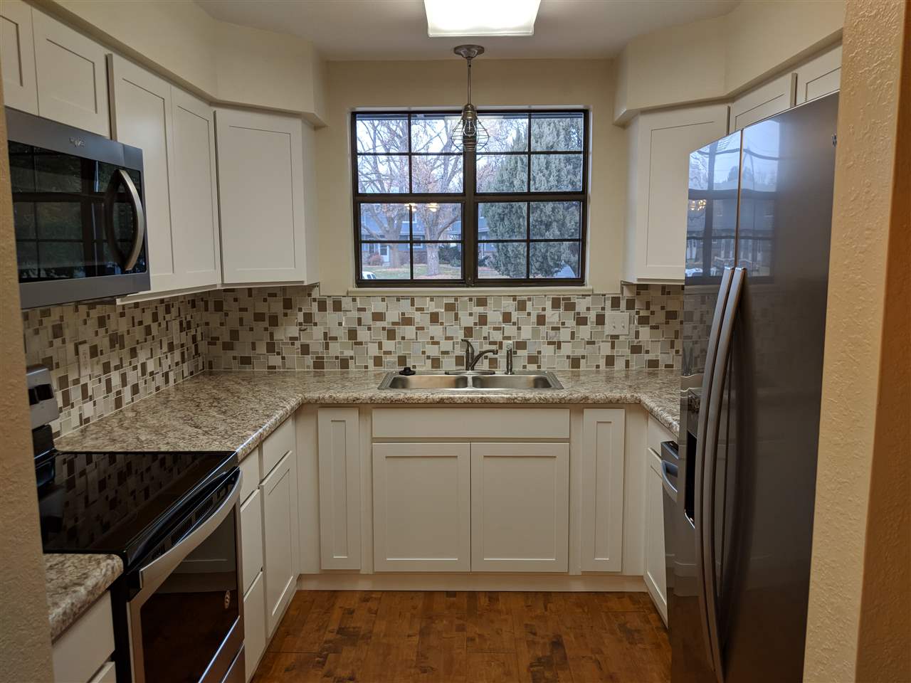 2721 Patterson Road, Unit 303 Grand Junction, CO 81506 - Photo 3 of 20 a kitchen with stainless steel appliances granite countertop a sink stove and refrigerator