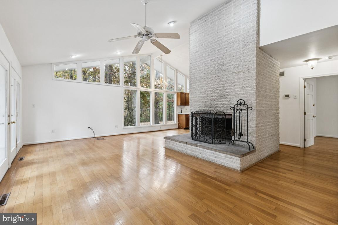 135 Lizzie Mills Road Castleton, VA 22716 - Photo 11 of 33 a view of a livingroom with wooden floor a fireplace and window