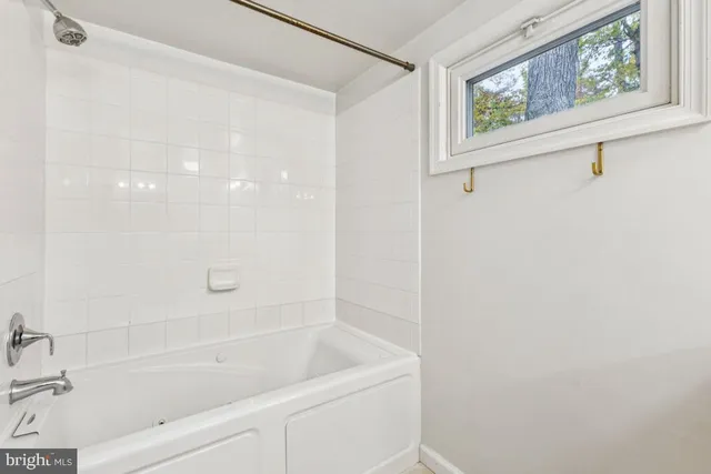 a bathroom with a bathtub and a shower