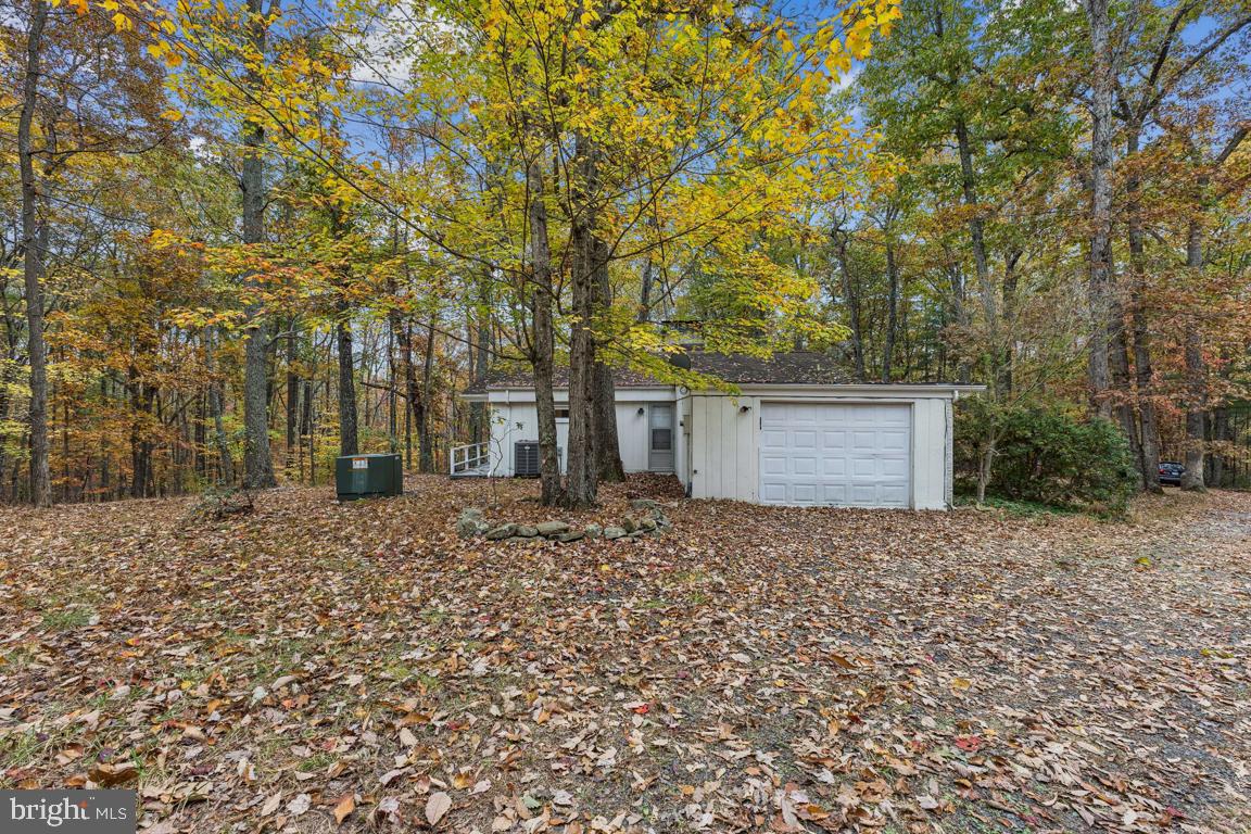 135 Lizzie Mills Road Castleton, VA 22716 - Photo 27 of 33 a front view of a house with a yard and garage