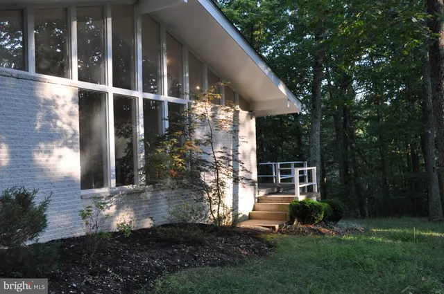 a view of a chair and table in backyard of the house