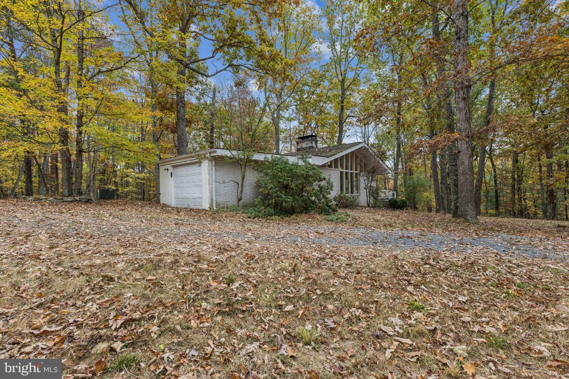 135 Lizzie Mills Road Castleton, VA 22716 - Photo 32 of 33 a view of a house with backyard and tree