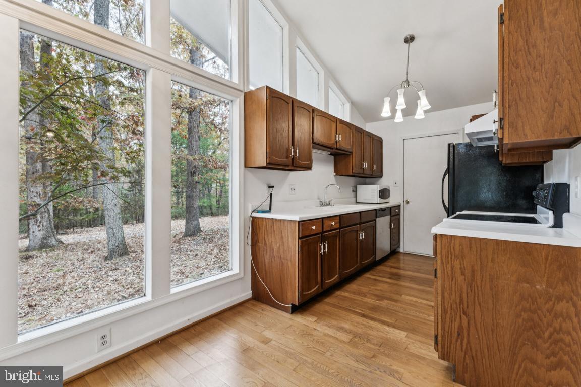 135 Lizzie Mills Road Castleton, VA 22716 - Photo 6 of 33 a large kitchen with stainless steel appliances granite countertop a stove a sink and a microwave
