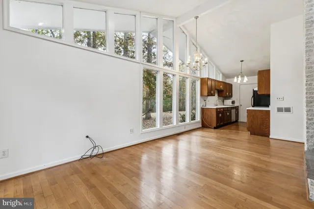 a view of a room with wooden floor and windows