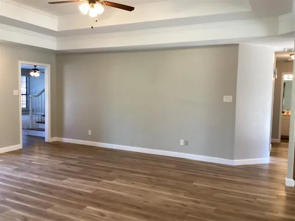 a view of an empty room with wooden floor