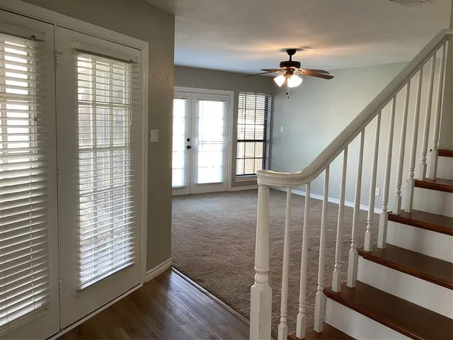 a view of entryway with wooden floor and fan