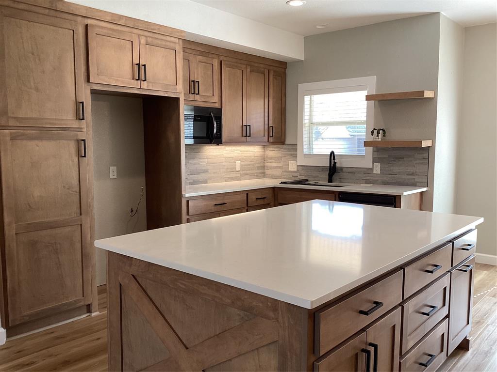 485 Cherokee Trail Keller, TX 76248 - Photo 4 of 33 a kitchen with kitchen island a sink stove and refrigerator
