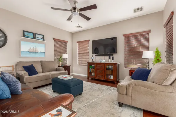 a living room with furniture and a view of kitchen