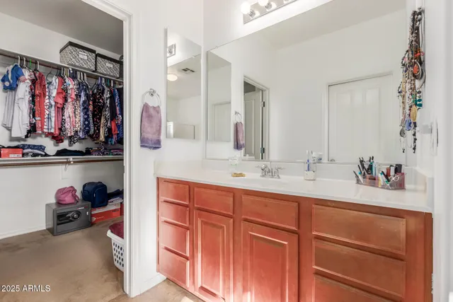 a view of walk in closet with clothes