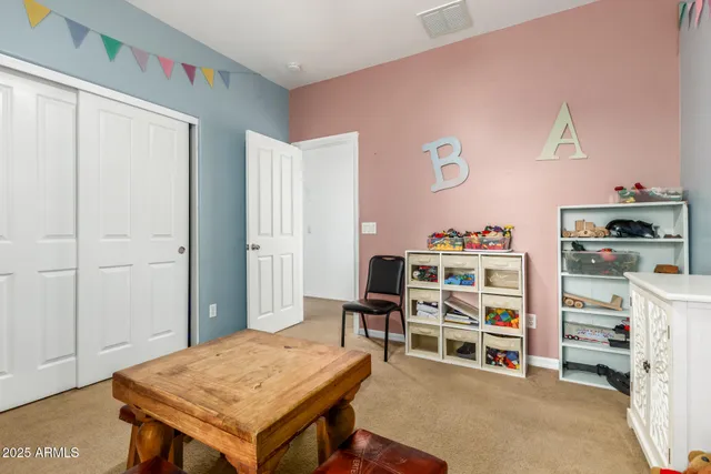 a room with a bed and a dresser