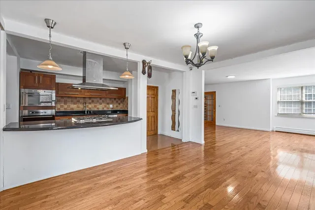 a view of a kitchen with a sink stainless steel appliances and cabinets