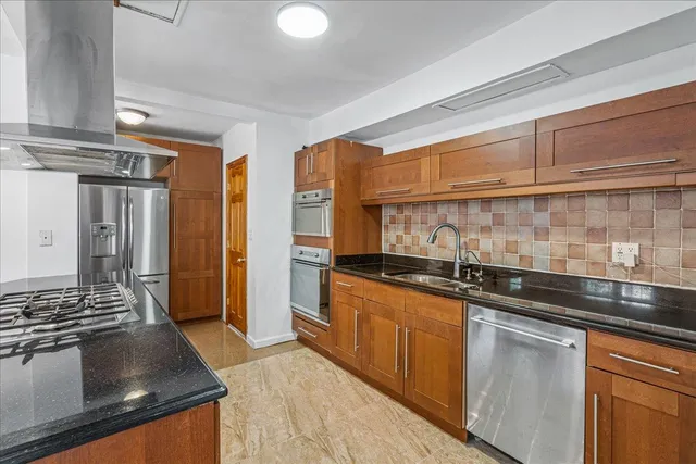 a kitchen with stainless steel appliances granite countertop a sink stove and refrigerator