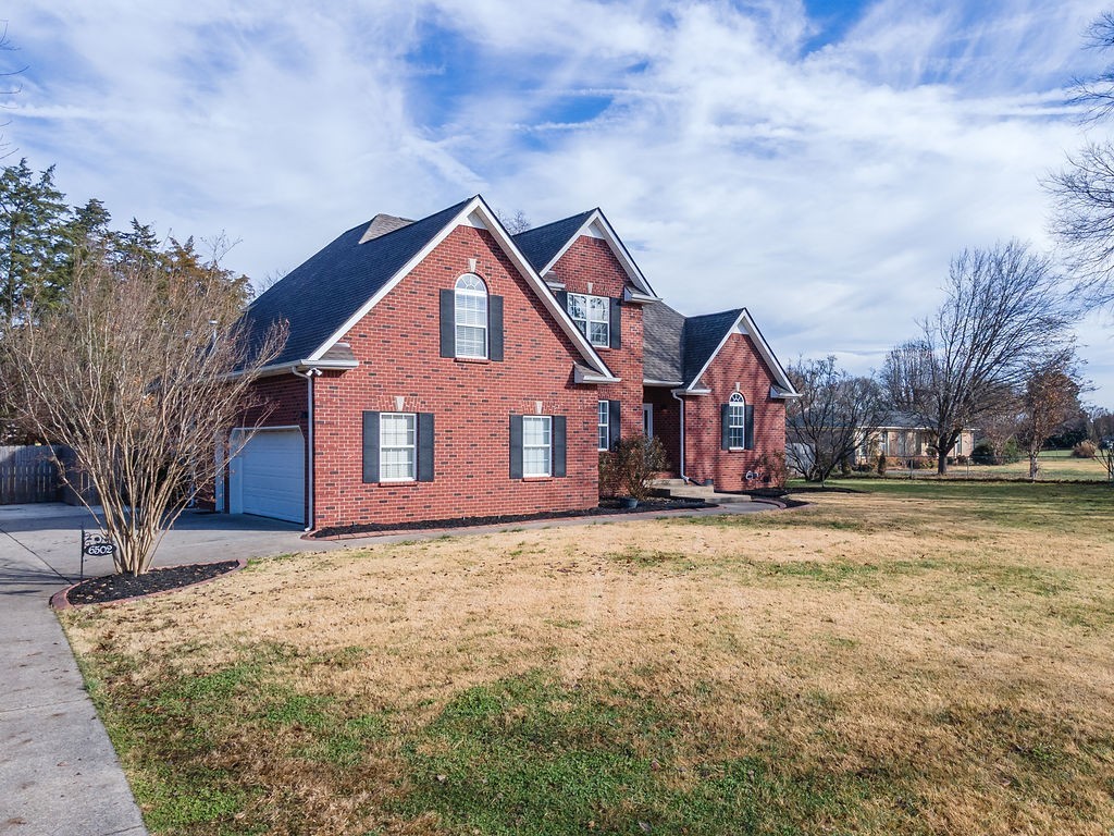 6502 Franklin Road Murfreesboro, TN 37128 - Photo 11 of 36 a front view of a house with a yard covered in snow
