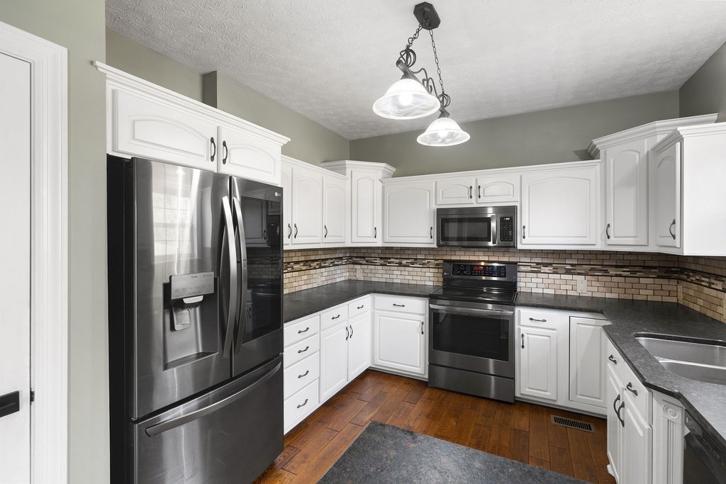 6502 Franklin Road Murfreesboro, TN 37128 - Photo 20 of 36 a kitchen with stainless steel appliances a refrigerator sink and cabinets