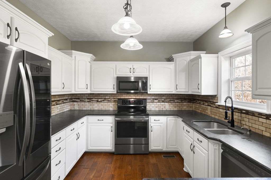 6502 Franklin Road Murfreesboro, TN 37128 - Photo 21 of 36 a kitchen with stainless steel appliances granite countertop white cabinets granite counter tops and a hard wood floors