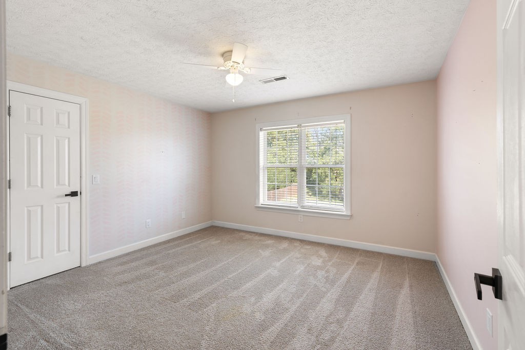 6502 Franklin Road Murfreesboro, TN 37128 - Photo 28 of 36 an empty room with chandelier fan and windows