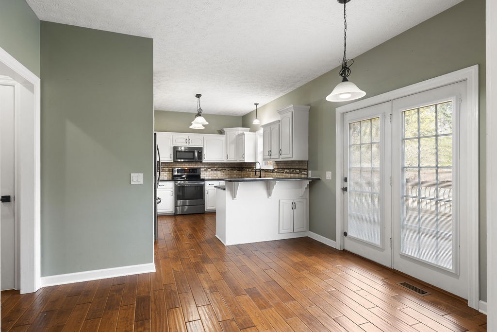6502 Franklin Road Murfreesboro, TN 37128 - Photo 5 of 36 a view of kitchen with stainless steel appliances kitchen island wooden floor and window