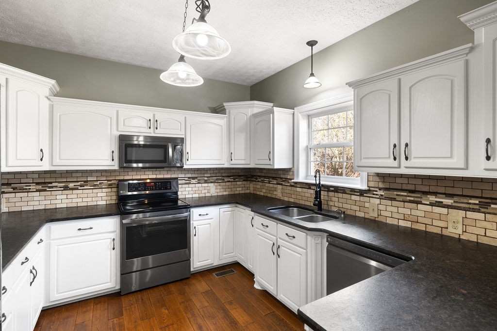 6502 Franklin Road Murfreesboro, TN 37128 - Photo 6 of 36 a kitchen with granite countertop a sink cabinets and stainless steel appliances