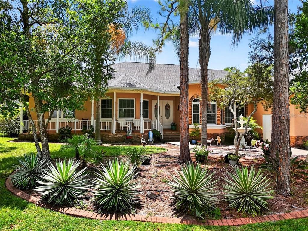a view of a house with backyard and a swimming pool