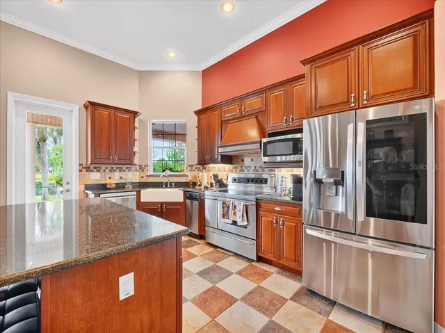 a kitchen with stainless steel appliances granite countertop a stove top oven