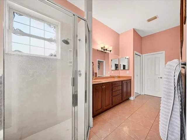 a bedroom with bed and wooden floor