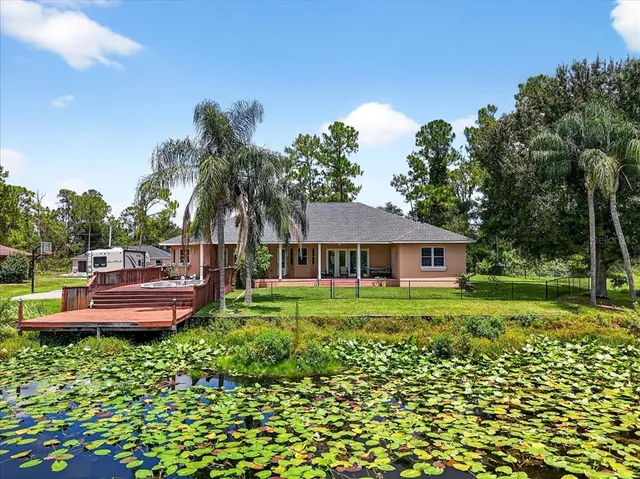 an aerial view of a house with yard swimming pool and outdoor seating
