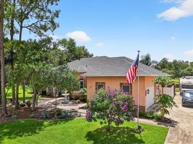 an aerial view of a house with swimming pool garden and patio
