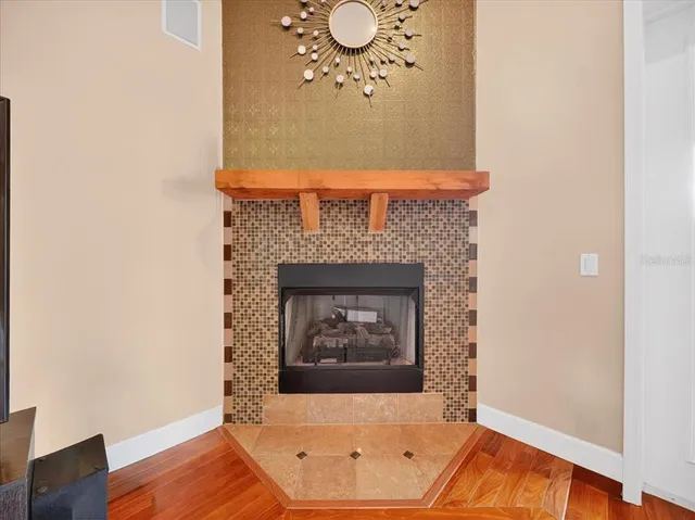 a living room with furniture a dining table and a floor to ceiling window