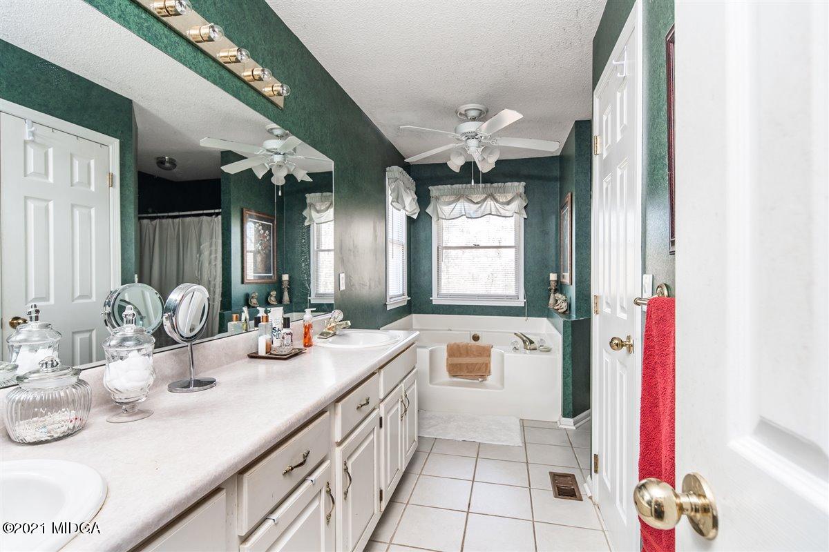 207 Ridge Court Macon, GA 31216 - Photo 22 of 28 a bathroom with a sink double vanity mirror and a bathtub