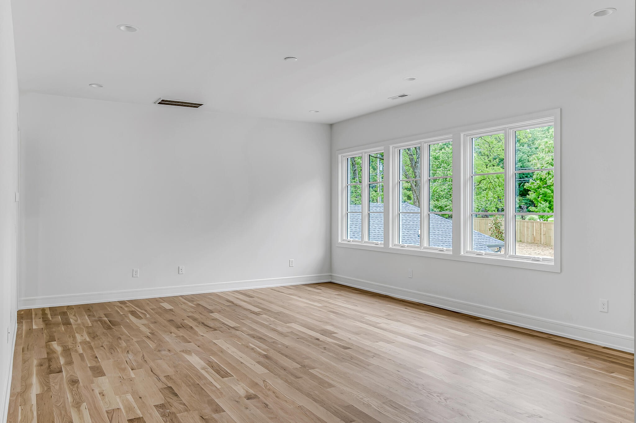 1401 Burton Valley Road Nashville, TN 37215 - Photo 44 of 68 a view of an empty room with wooden floor and a window