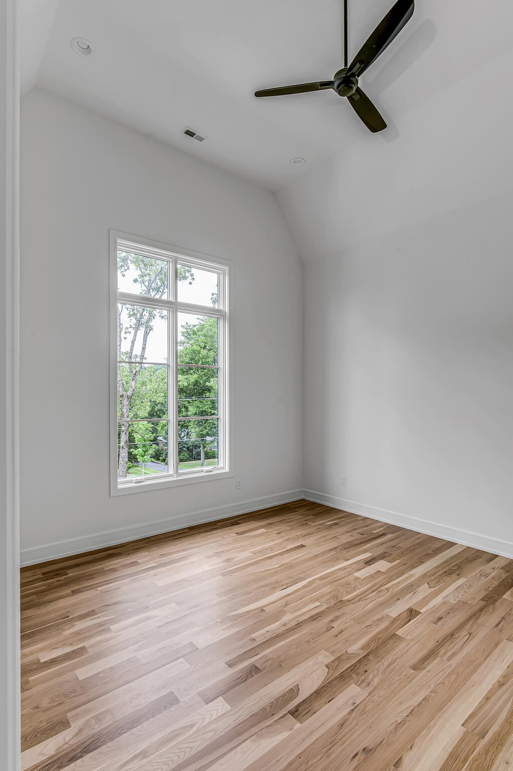 1401 Burton Valley Road Nashville, TN 37215 - Photo 57 of 68 a view of an empty room with wooden floor and a window
