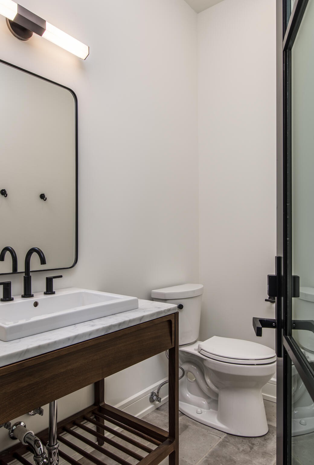 1401 Burton Valley Road Nashville, TN 37215 - Photo 65 of 68 a bathroom with a sink a toilet and mirror