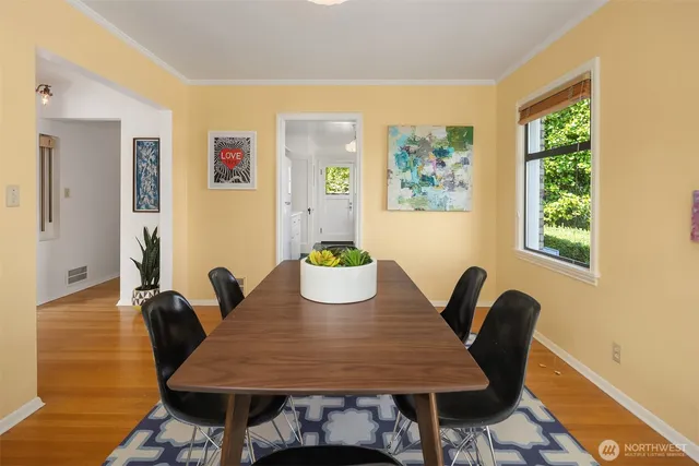 a view of a dining room with furniture window and wooden floor