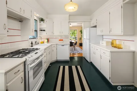 a kitchen with a sink stove and cabinets
