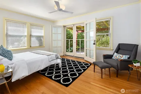 a bedroom with a bed and wooden floor