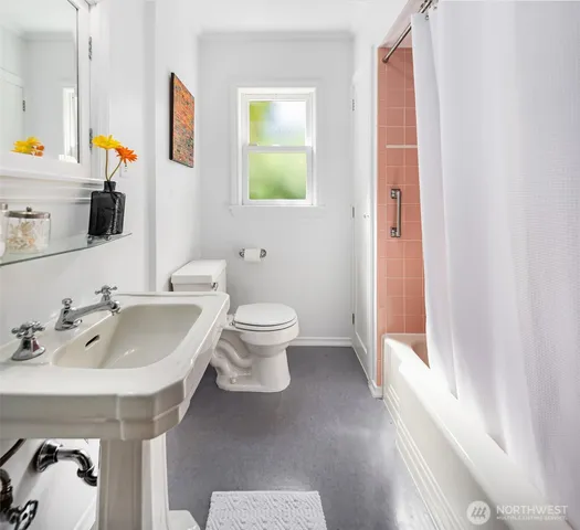 a spacious bathroom with a sink and a mirror