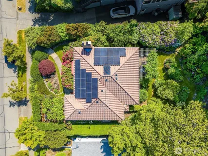 an aerial view of a house with a yard and potted plants